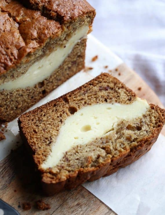 Cheesecake Stuffed Banana Bread...it's a classic treat turned on it's head. The thick ribbon of cheesecake is creamy, rich and the perfect pairing with the buttery banana bread!