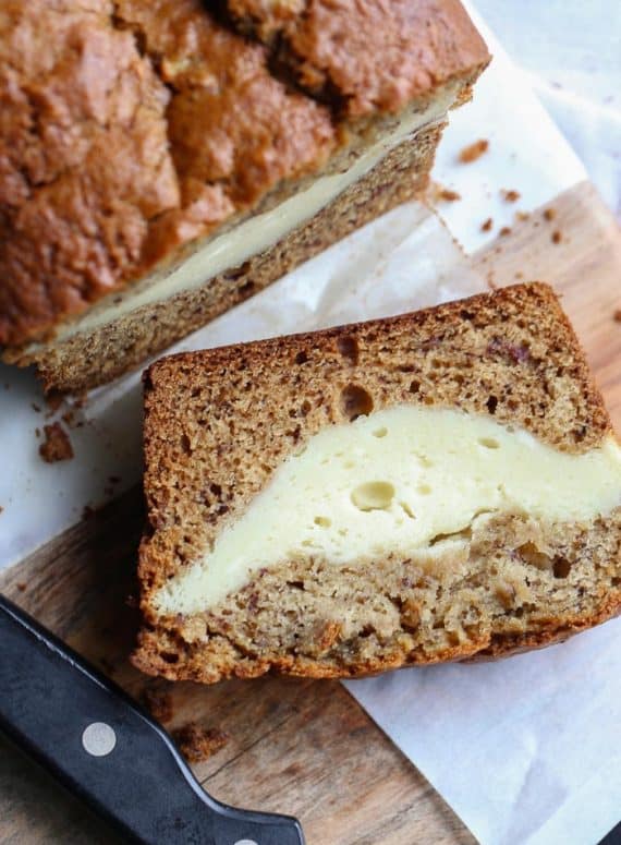 Cheesecake Stuffed Banana Bread...it's a classic treat turned on it's head. The thick ribbon of cheesecake is creamy, rich and the perfect pairing with the buttery banana bread!