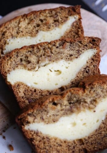 Cheesecake Stuffed Banana Bread...it's a classic treat turned on it's head. The thick ribbon of cheesecake is creamy, rich and the perfect pairing with the buttery banana bread!