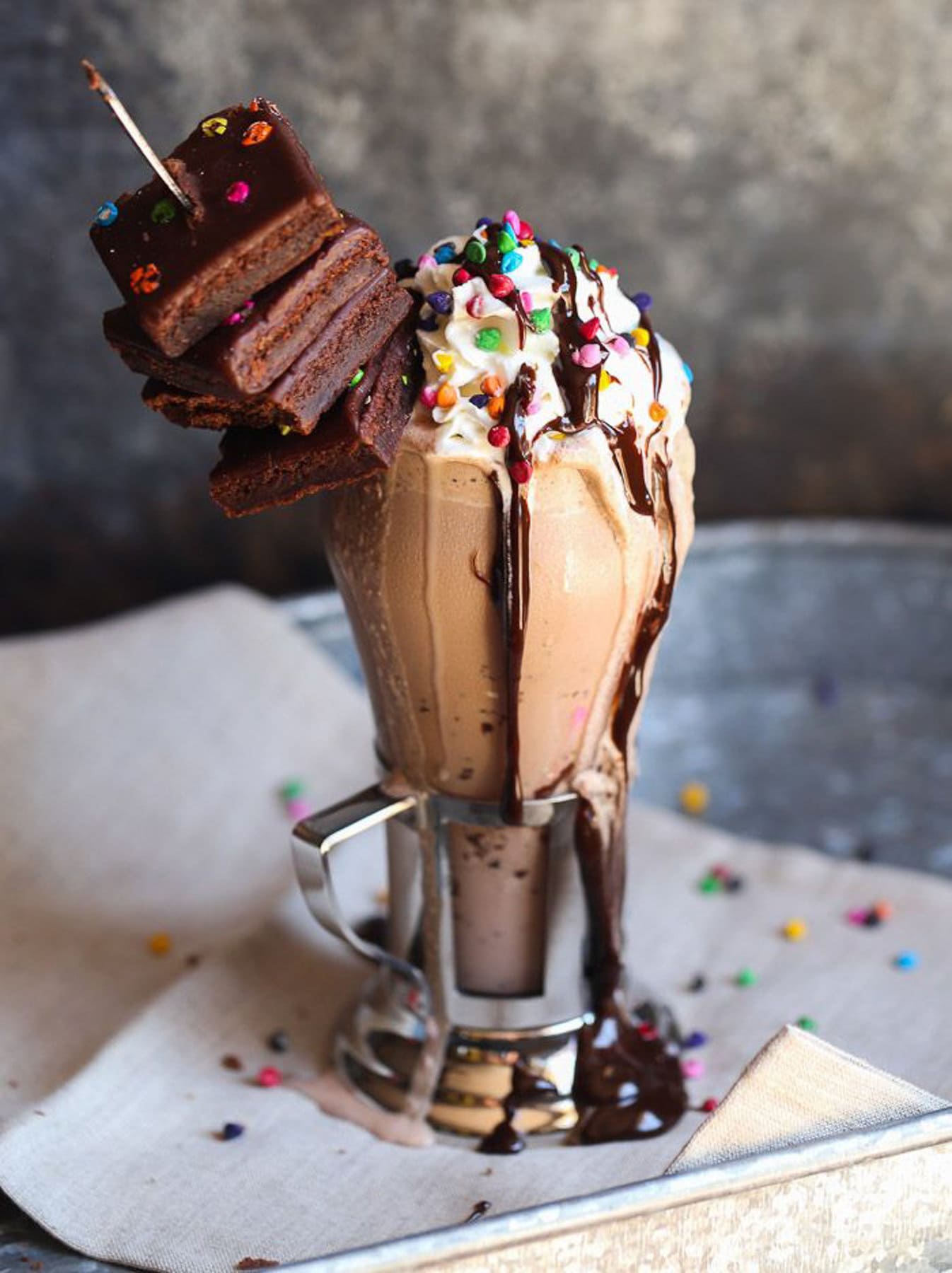 Rainbow Chip Brownie Milkshake served with whipped cream and brownies on top