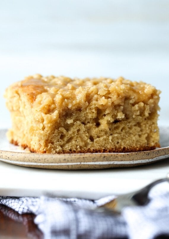 Slice of coffee cake on a plate with crumb topping