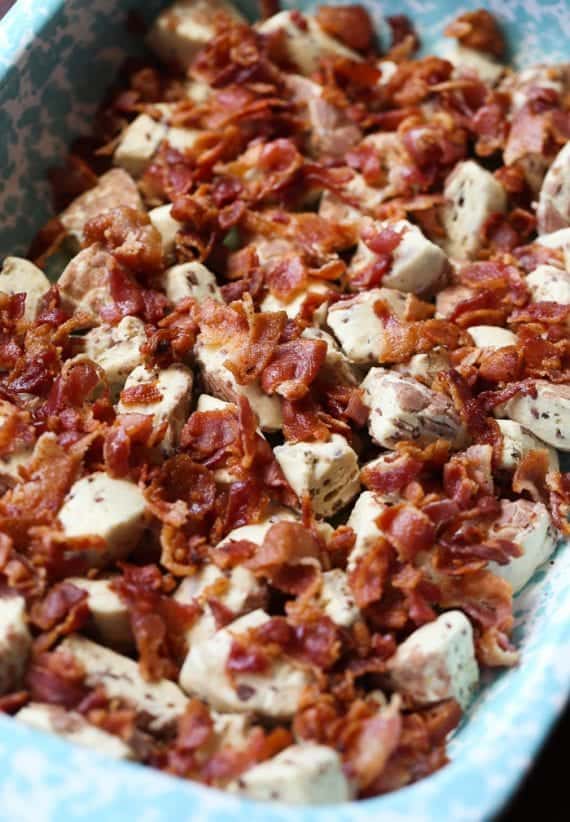 Cinnamon Roll chunks and crumbled bacon in a baking dish