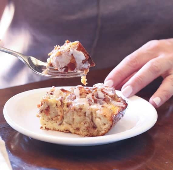 Cinnamon Roll Breakfast Bake serving on a plate with a bite on a fork