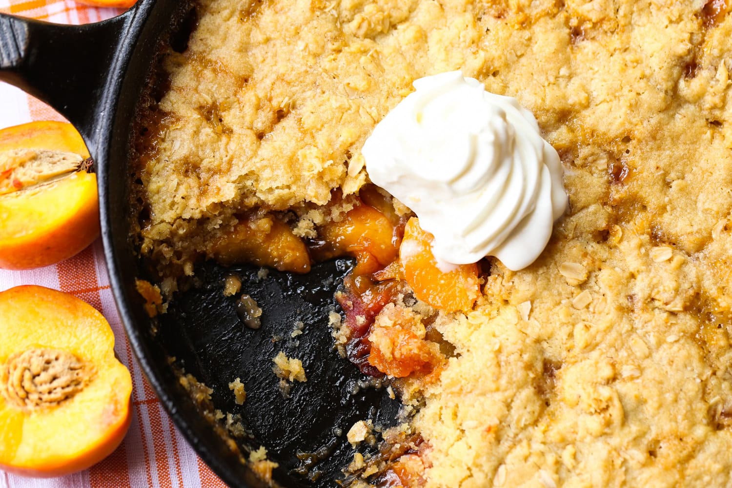 Skillet sugar cookie cobbler topped with whipped cream
