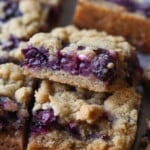 Close up of Blueberry Crumb Bars stacked on a countertop.
