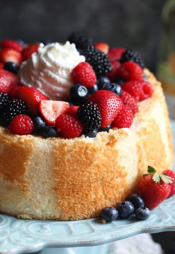 Soft and light Angel Food Cake topped with Wine Soaked Berries! So easy and elegant!