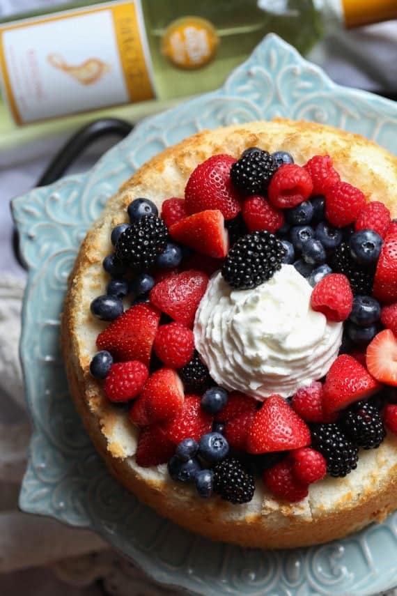 Soft and light Angel Food Cake topped with Wine Soaked Berries! So easy and elegant!