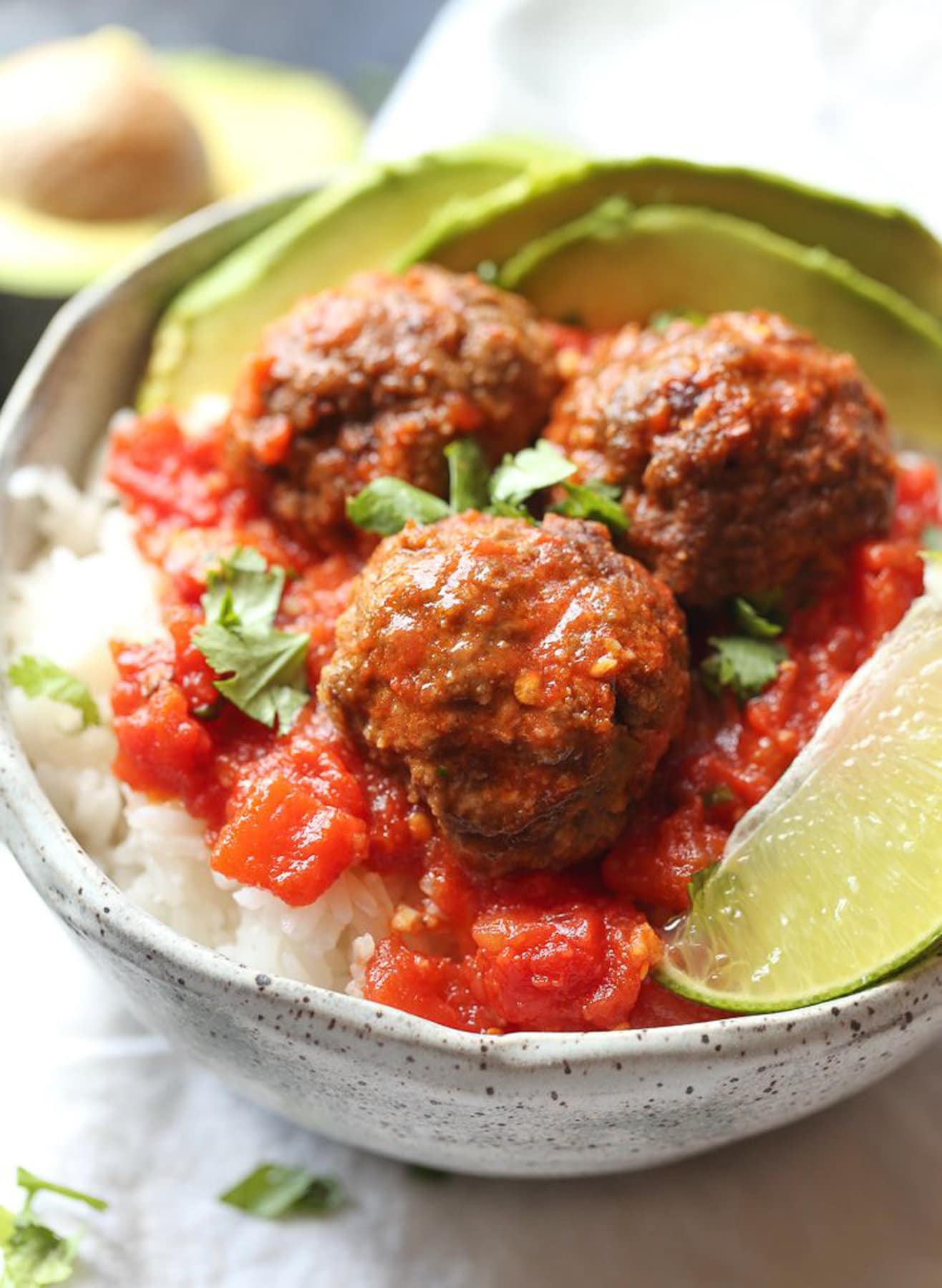 Chipotle meatballs served on rice with avocado 