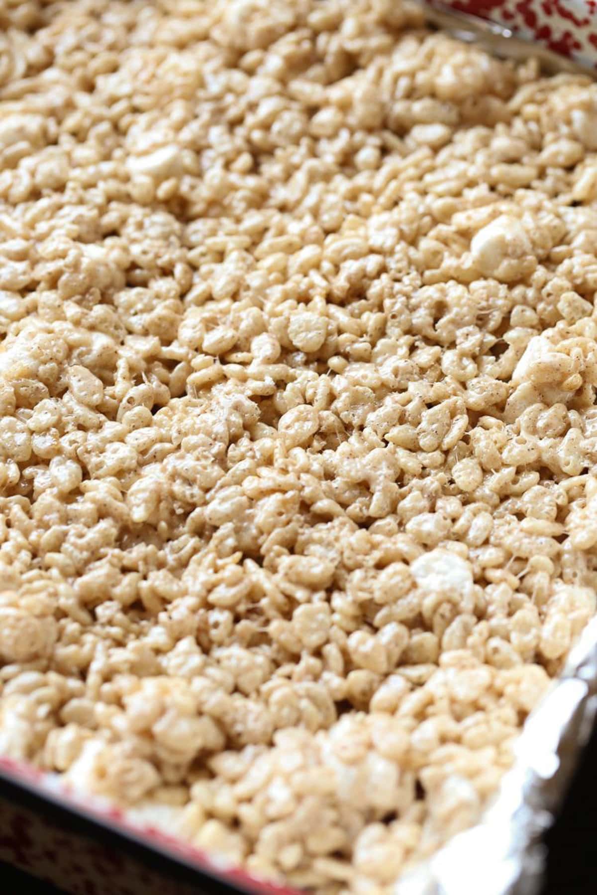 Rice krispie treats pressed down into a pan