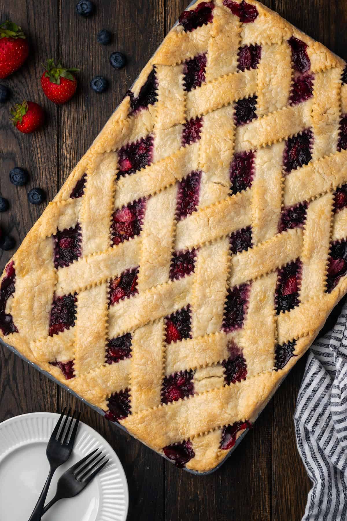 Overhead view of berry slab pie with a lattice crust.