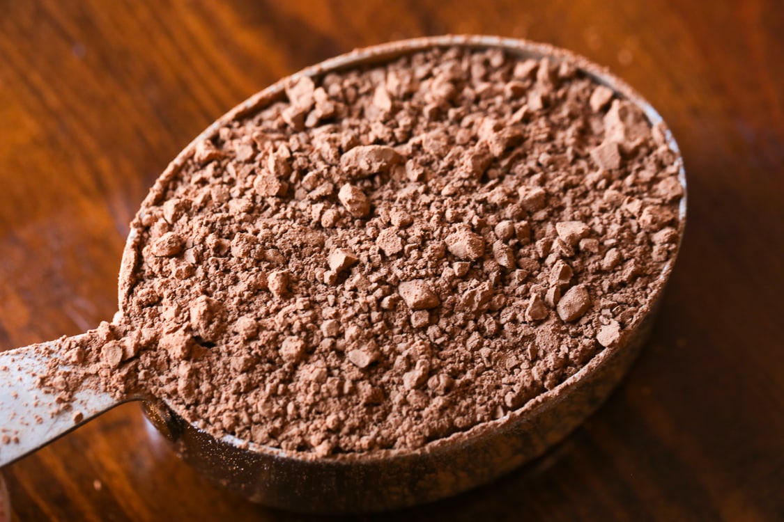A Metal Measuring Cup Filled with Cocoa Powder
