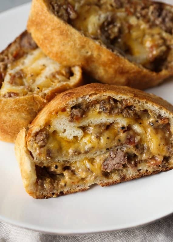 GARBAGE BREAD!! This is a simple recipe that can be adapted SO many ways! Bacon Cheeseburger Garbage Bread is our favorite, but throw your leftovers in a pizza crust and roll it up! The possibilities are endless.