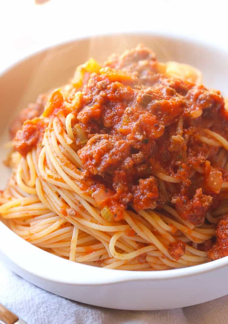 A bowl of spaghetti topped with slow cooker bolognese.