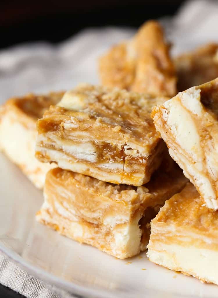 Dulce de Leche Swirled Vanilla Fudge squares stacked on a plate.