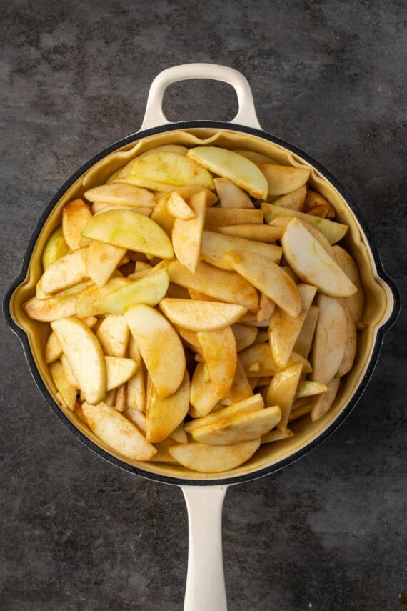 Sliced cinnamon apples added to the skillet.