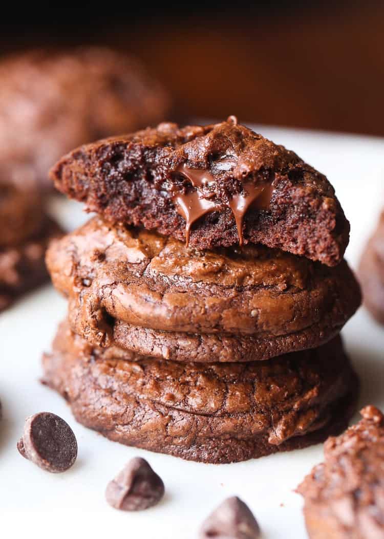 A Stack of Three Chocolate Truffle Cookies with the Top One Broken in Half