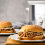 Crock Pot Philly Cheesesteak Sloppy Joes in a bun on a plate.
