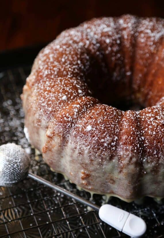 Glazed eggnog butter cake on a wire rack.