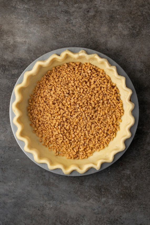 A pie crust filled with toffee bits.