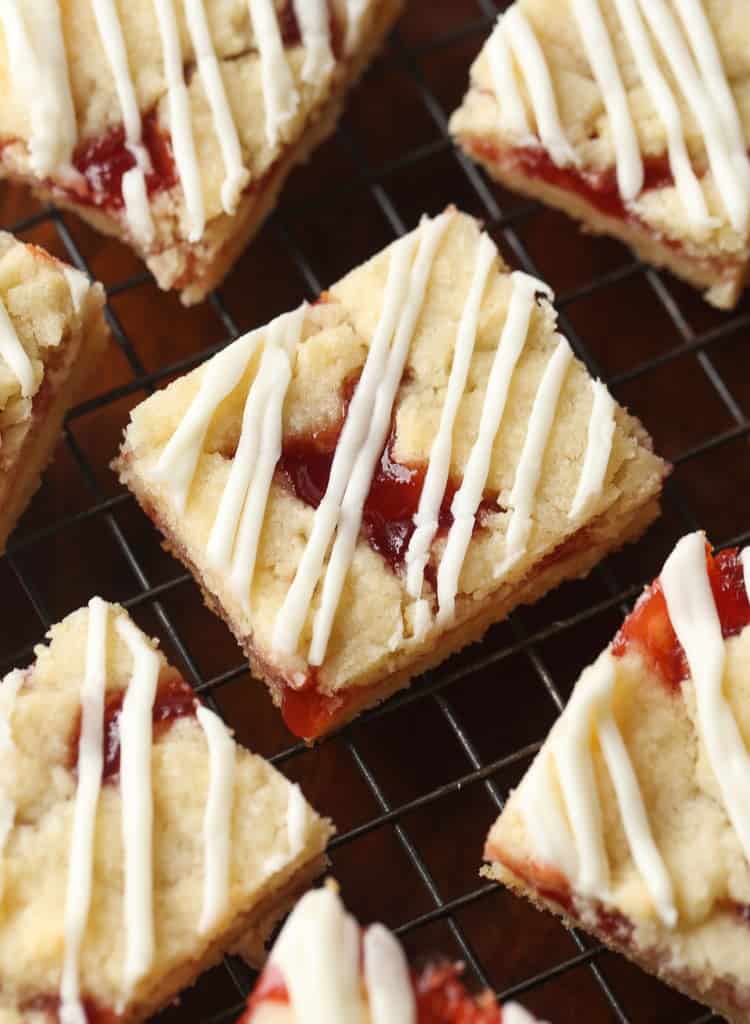 Strawberry Shortbread Bars drizzled with glaze.