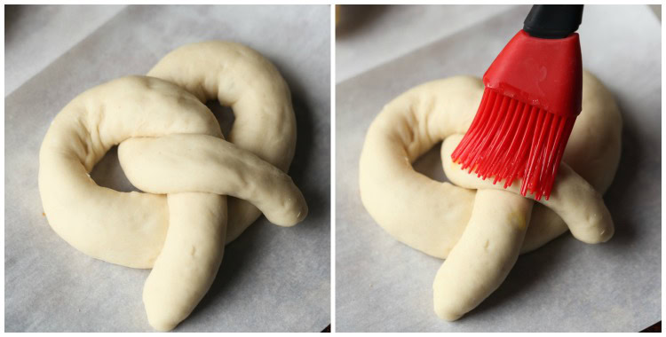 Unbaked soft pretzels are brushed with egg wash.