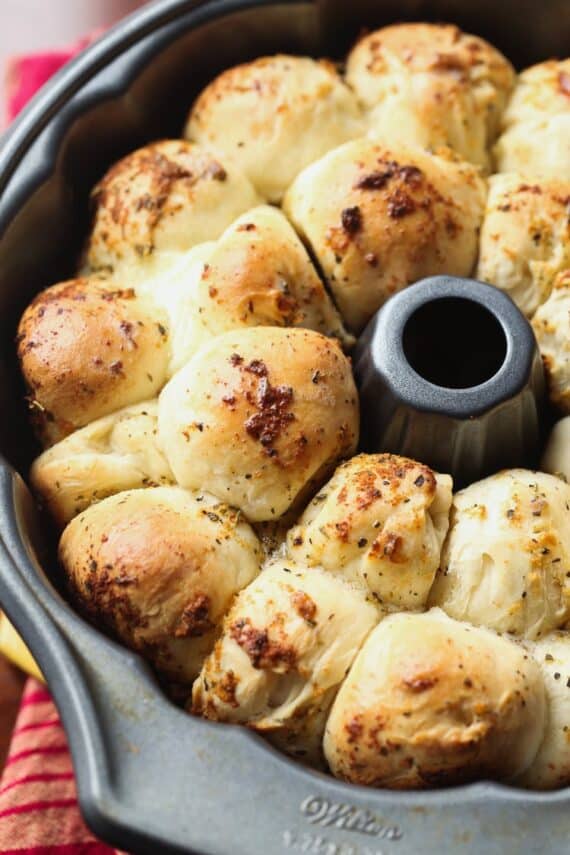 This Cheesy Garlic Pull-Apart Bread is stuffed with mozzarella cheese and coated in herb butter. Crazy good as a side dish, or dipped in marinara for a meal!