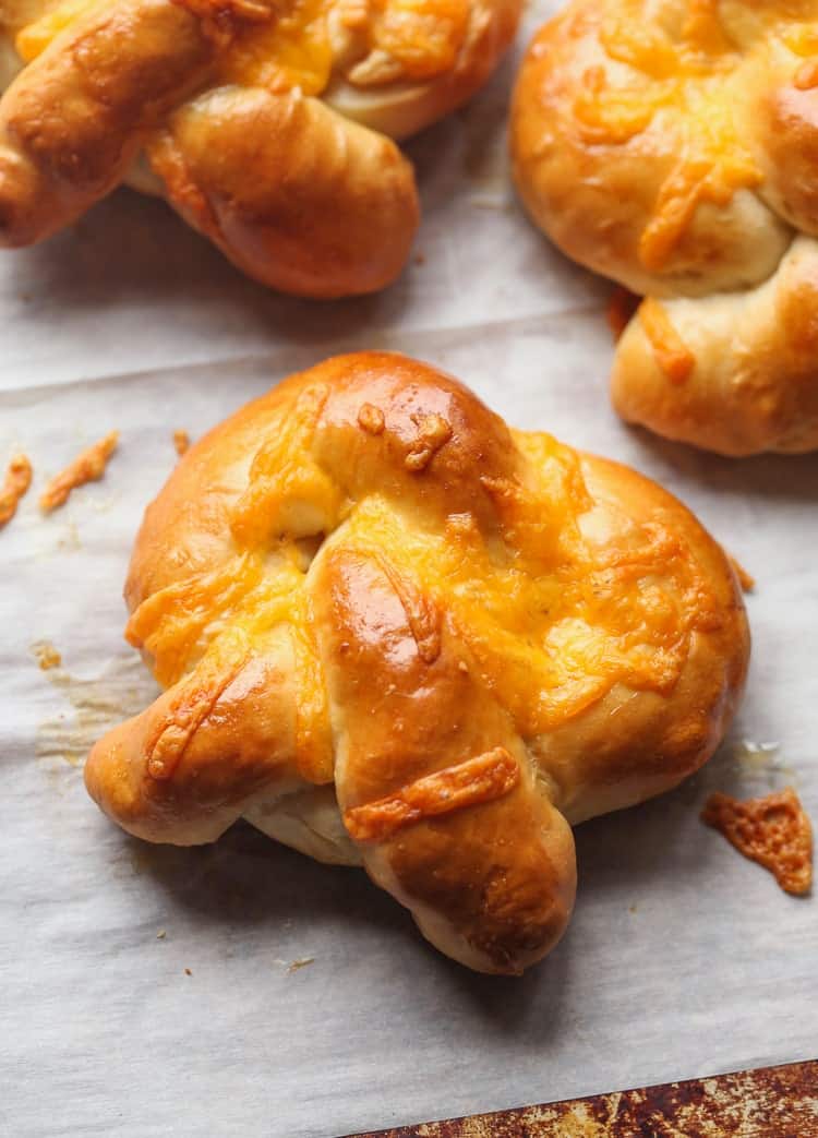 Easy and cheesy homemade soft pretzels laid out on parchment paper.