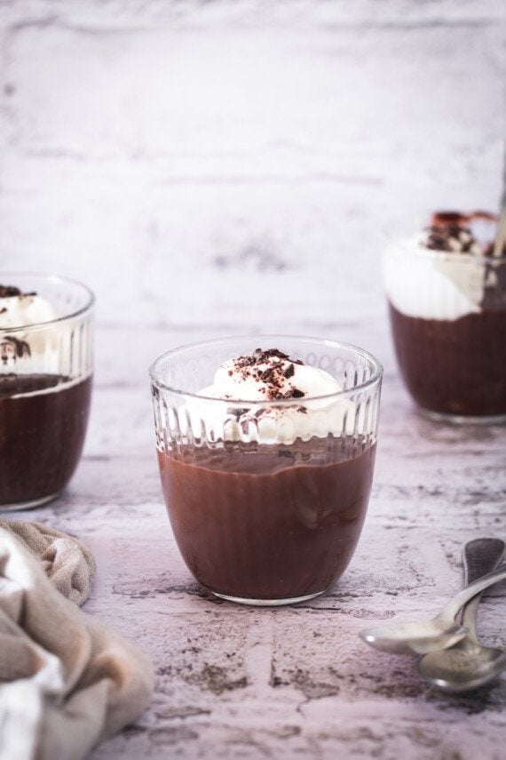 Chocolate pudding cups with whipped cream.