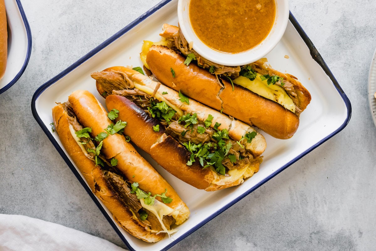 French dip sandwiches on a platter.
