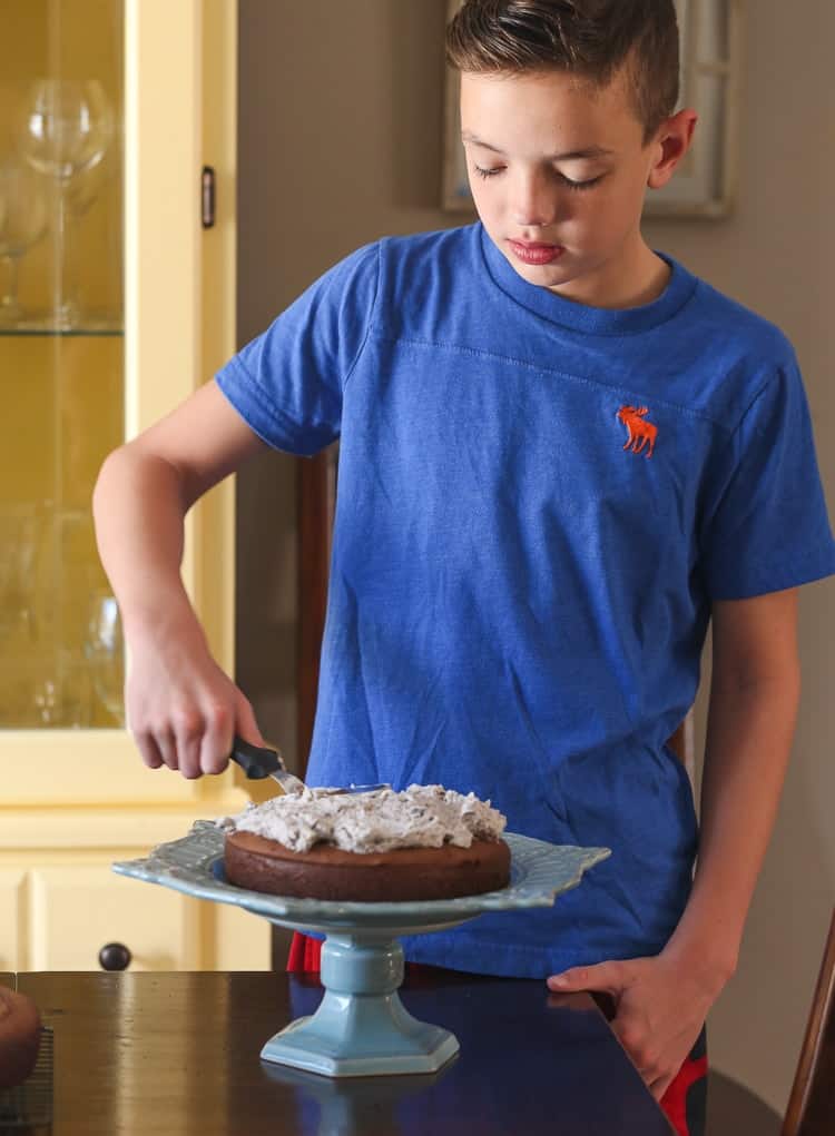 My Son Max Spreading a Thick Layer of Oreo Frosting Over a Layer of Chocolate Cake