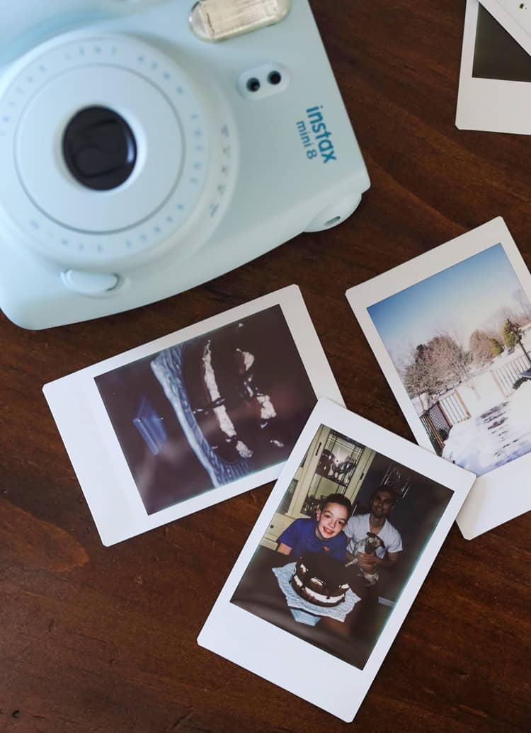 Max's Instax Photos of our Chocolate Cake with Oreo Frosting on a Wooden Table with His Polaroid Camera