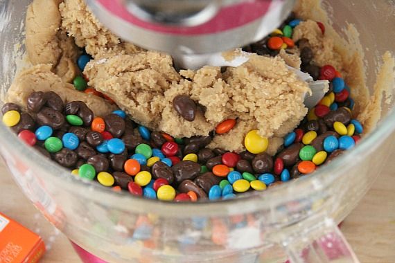 Cookie dough with candy pieces in a stand mixer bowl