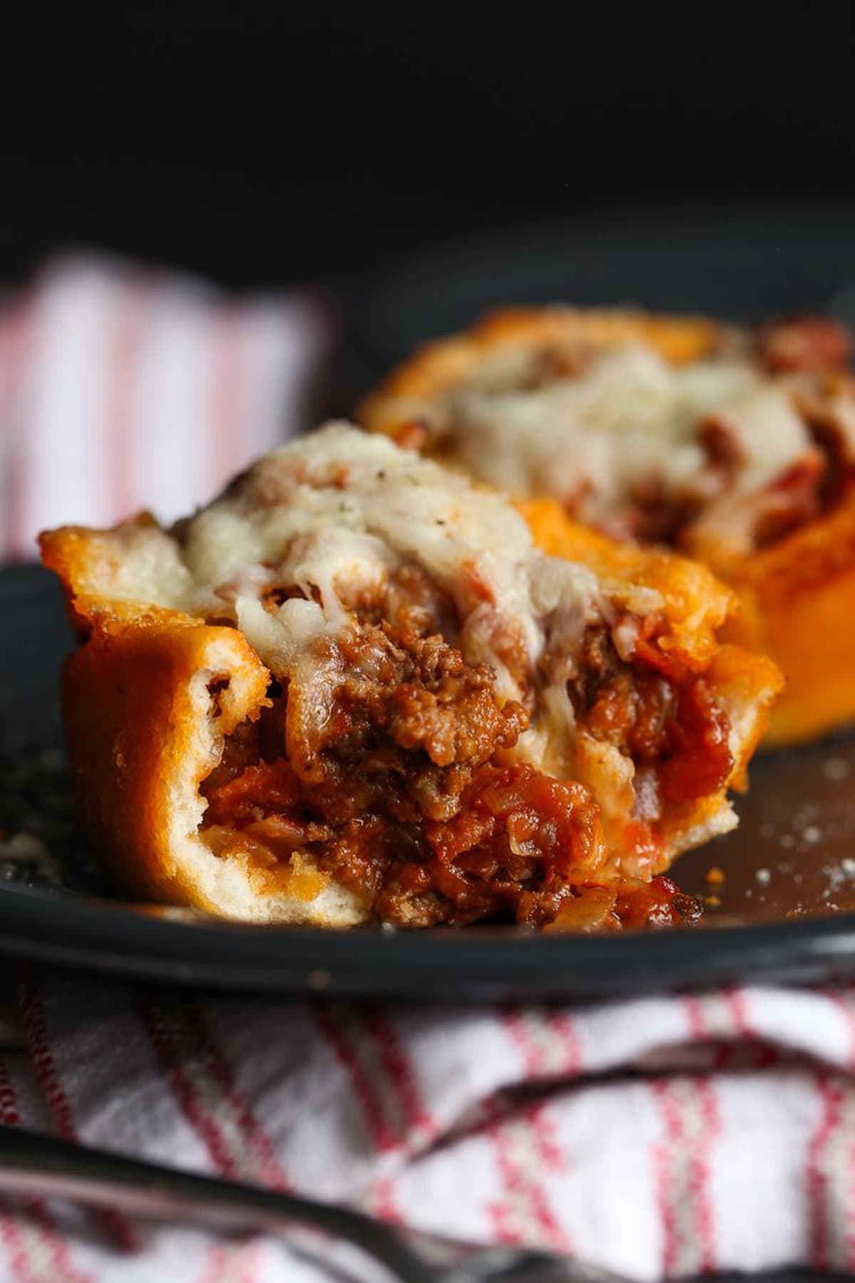 Pizza muffin showing off inside and melted cheese