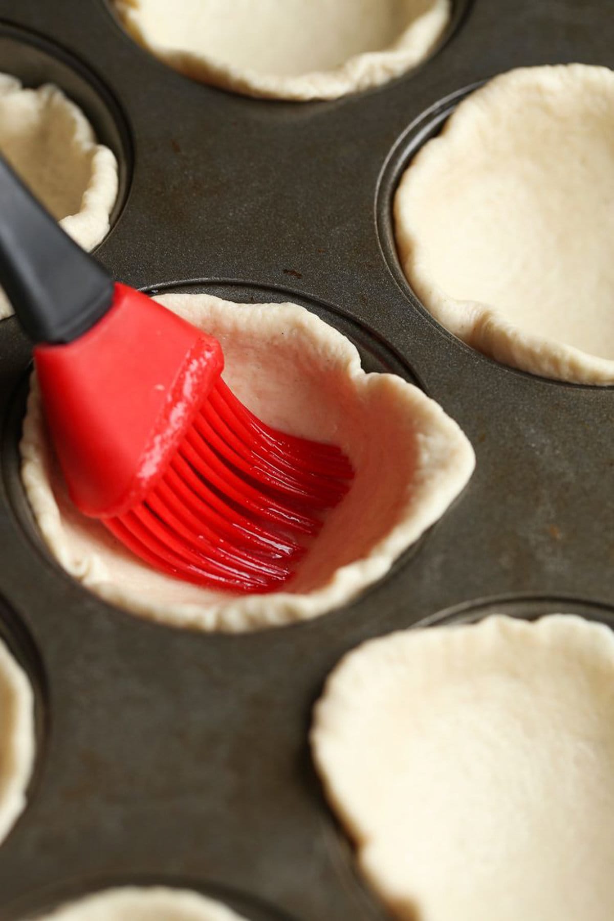 Spreading garlic butter on to biscuits 