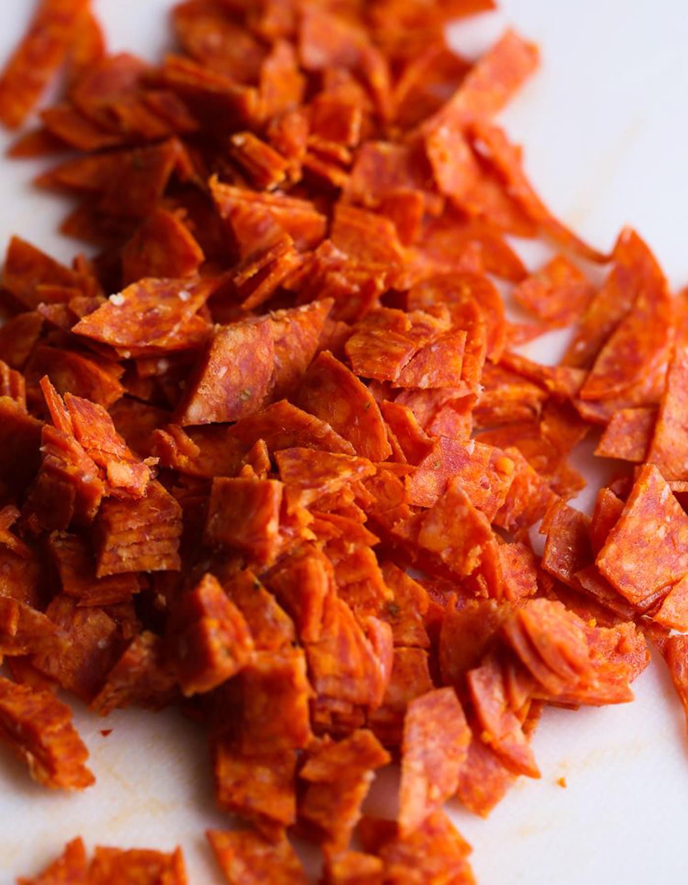 Diced pepperoni on a cutting board 