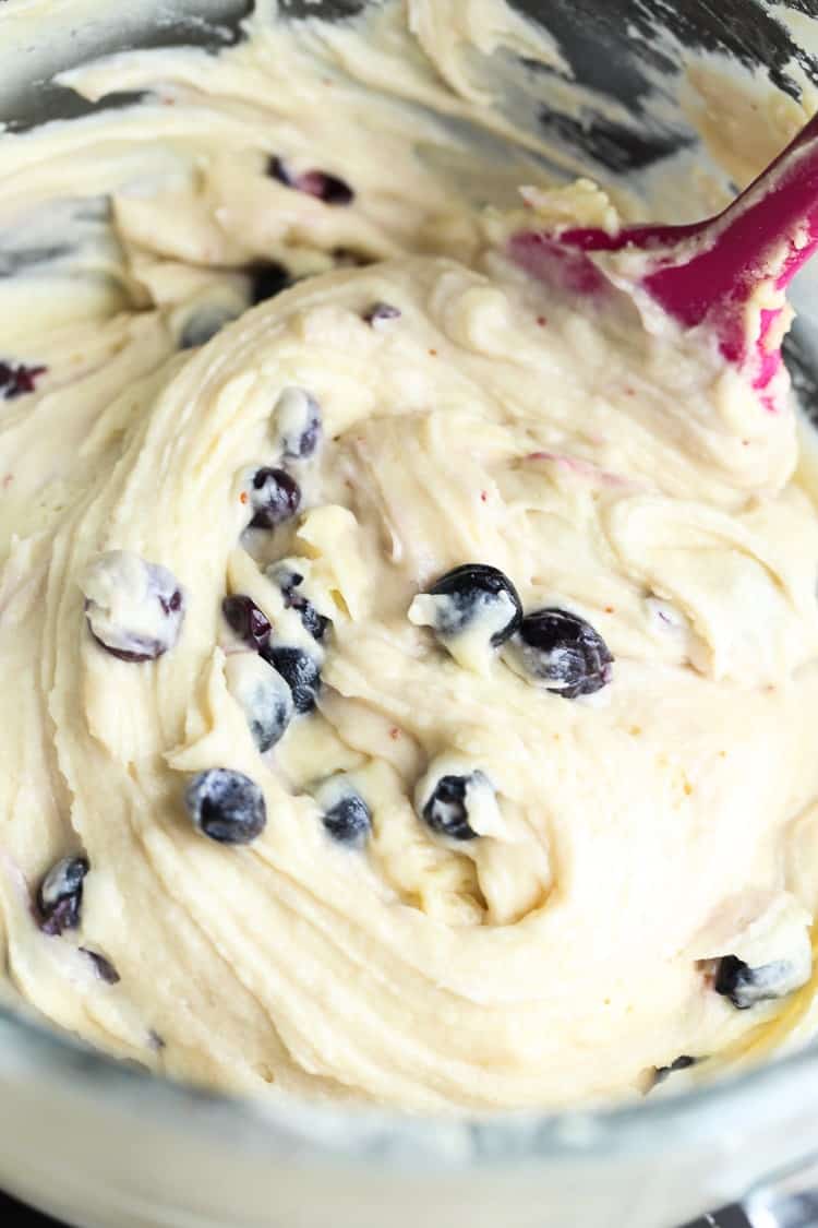 Folding blueberries into cake batter.