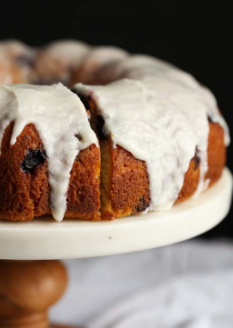 Blueberry bundt cake on a cake stand.