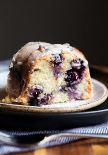 A slice of blueberry bundt cake on a plate.