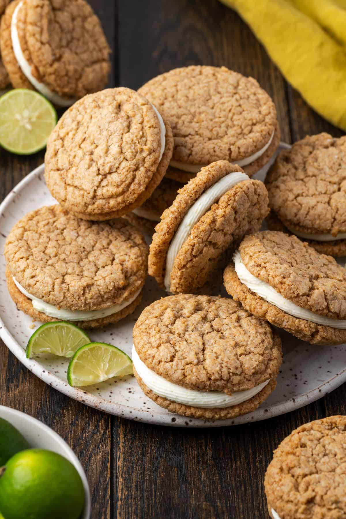 Overhead view of key lime sandwich cookies piled on a plate.