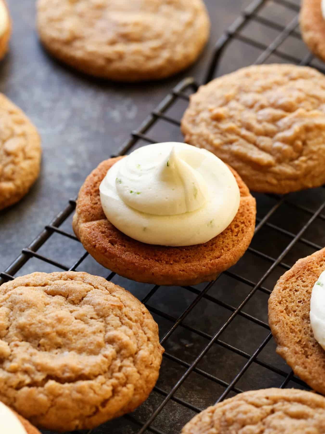 Graham cookies on a wire rack, with key lime buttercream swirled on top of one cookie.