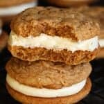 Two Key Lime Pie Sandwich Cookies staked on one another, with a bite missing from the top cookie.
