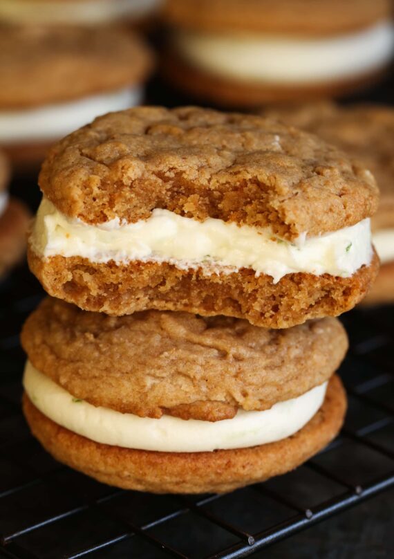 Two Key Lime Pie Sandwich Cookies staked on one another, with a bite missing from the top cookie.