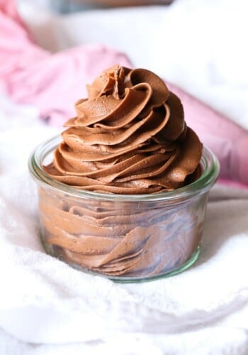 Creamy chocolate frosting swirled in a glass dish.