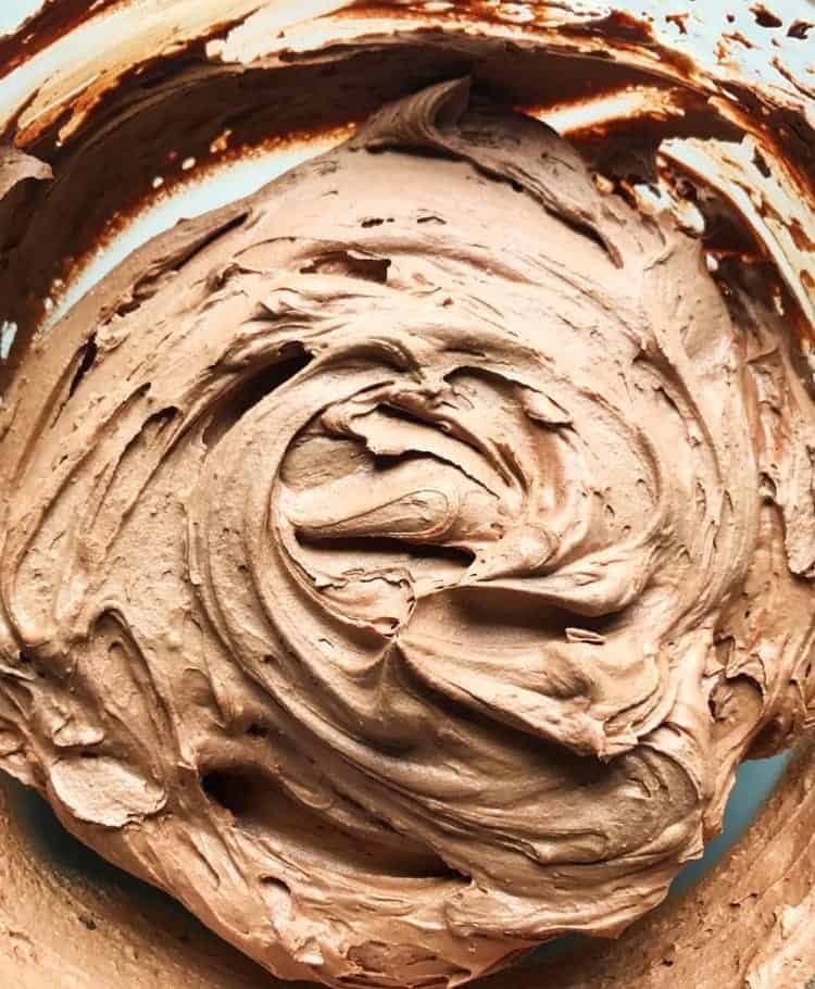 Chocolate buttercream frosting in a mixing bowl.