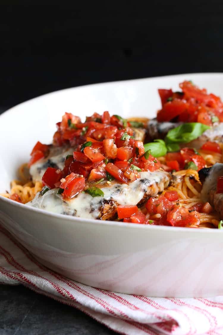 Grilled bruschetta chicken served over a bed of spaghetti.