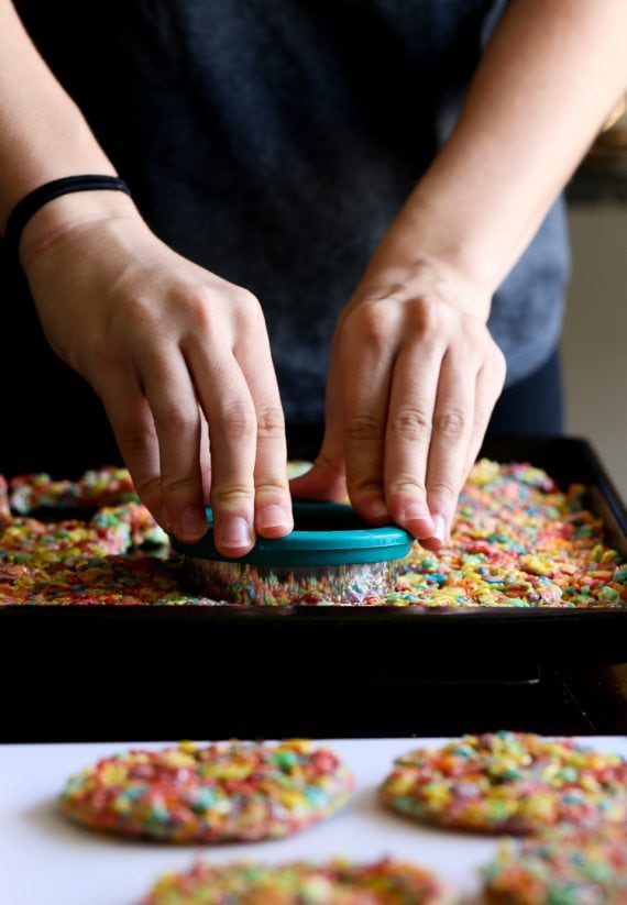 Circles of Fruity Pebble krispies being cut for ice cream sandwiches