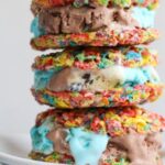 A stack of Fruity Pebble ice cream sandwiches on a plate