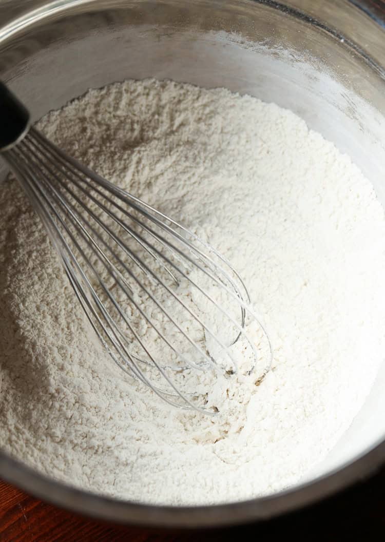 A Metal Whisk Combining the Dry Scone Ingredients in a Mixing Bowl