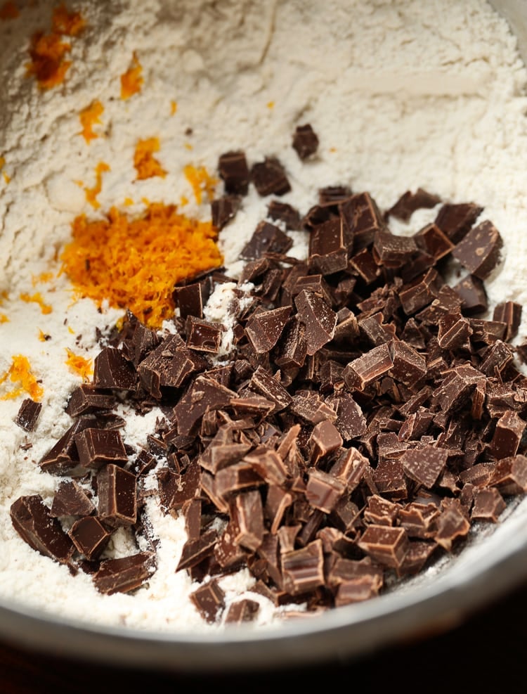 Chunks of Semi-Sweet Chocolate and Orange Zest on Top of the Dry Ingredient Mixture