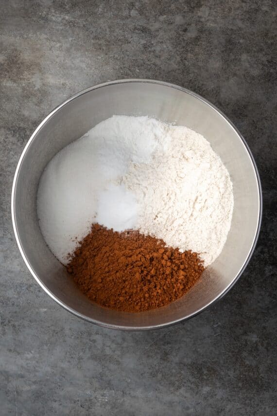 Dry chocolate cake ingredients combined in a mixing bowl.